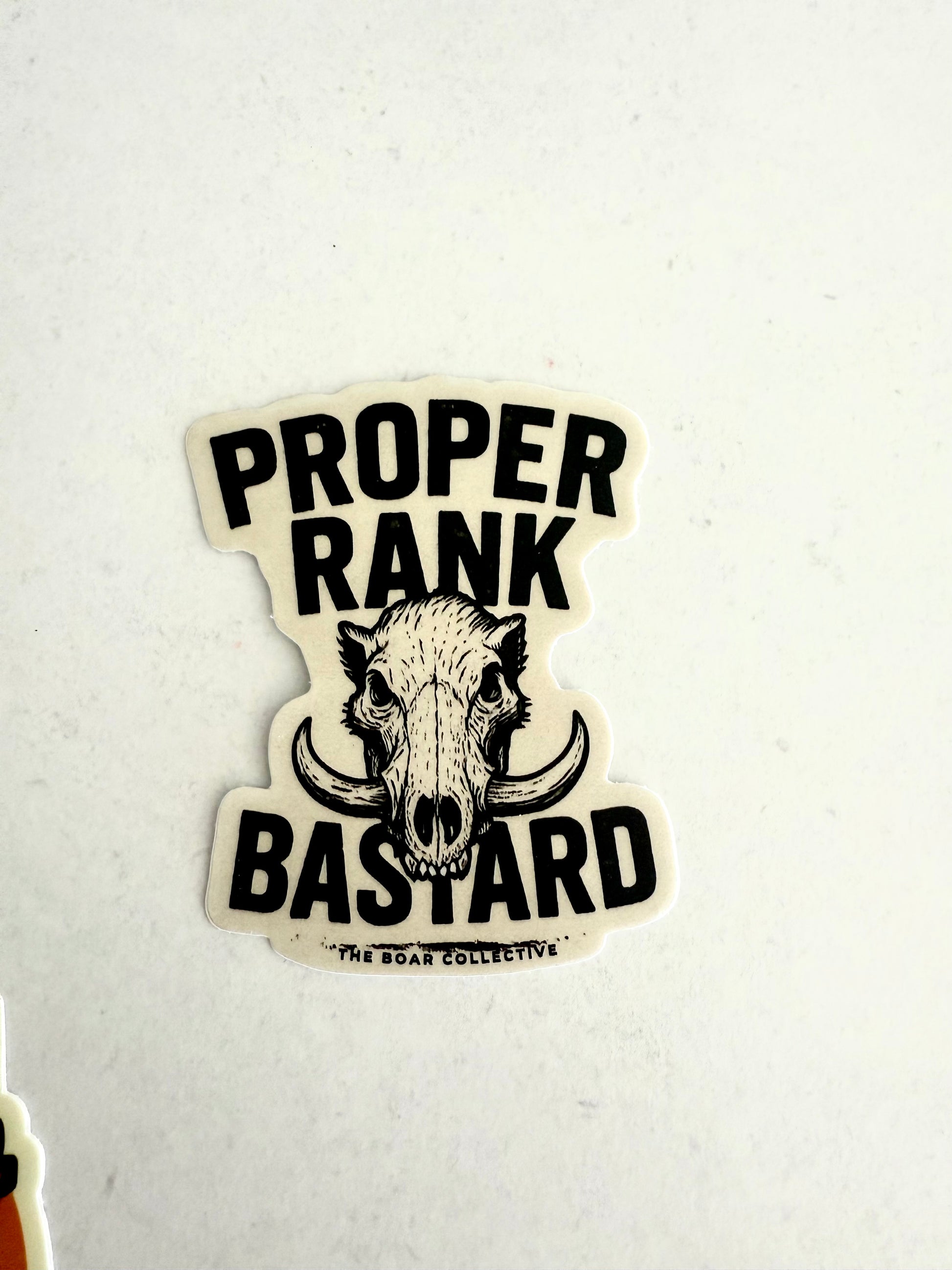 Proper Rank Bastard sticker featuring a wild boar skull with tusks by The Boar Collective