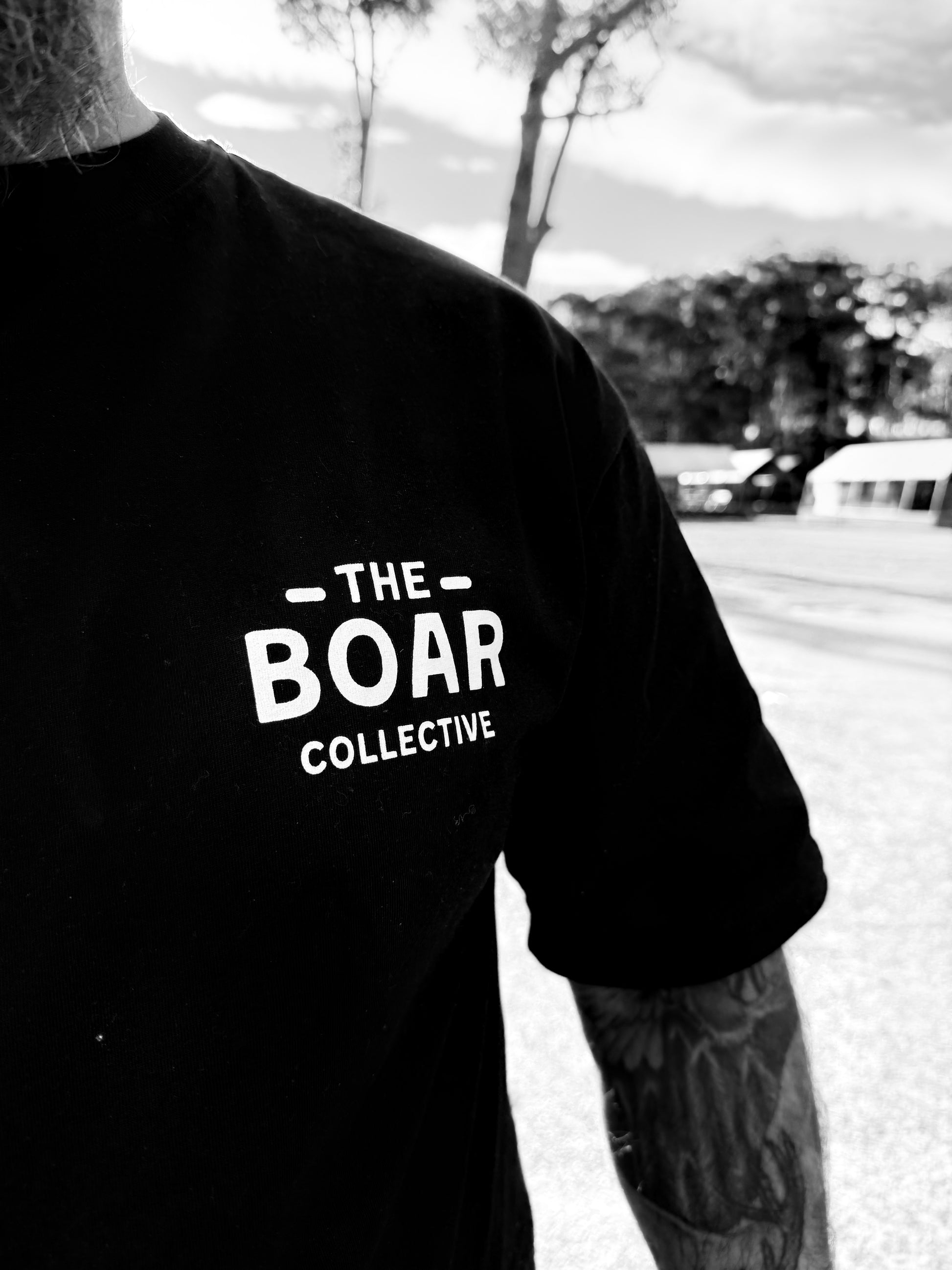 The Boar Collective black t-shirt front logo close up - boar hunting lifestyle apparel for hunters and outdoor enthusiasts
